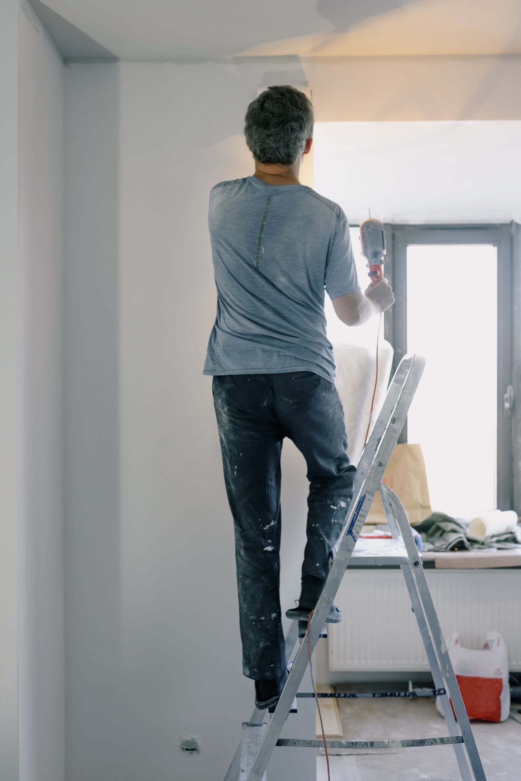 Tradesperson working from a ladder during a home repair
